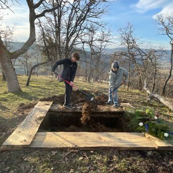 filling in the grave at a natural burial ceremony