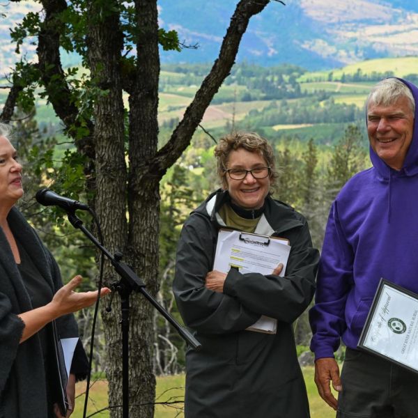 Great River Natural Burial Ground owners receive Green Burial Council certification from Rachel Essig during opening celebration on May 17, 2025