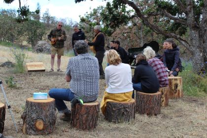 friends and family listen to music at funeral
