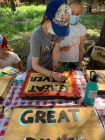 campers paint road and trail signs