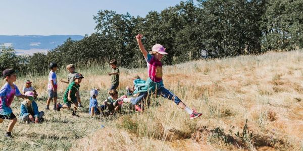 nature day campers enjoy playing in grassy meadow